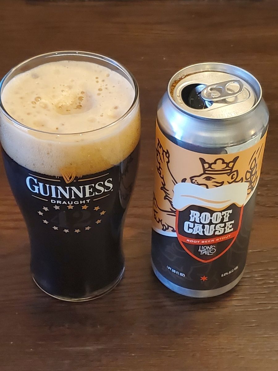Empty Can of Lion's Tail Root Cause Next to Guinness Glass with Beer in it