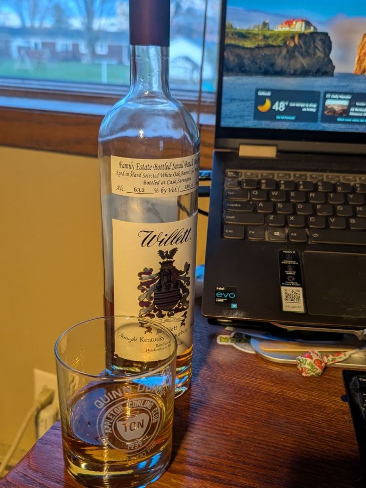 Willett Purple Top Bottle and Glass on Desk Next to Computer